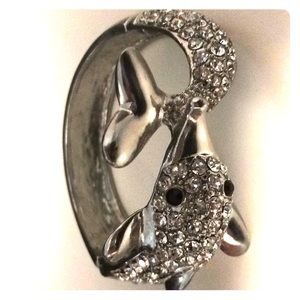 It’s a silver diamond incrusted dolphin bracelet.